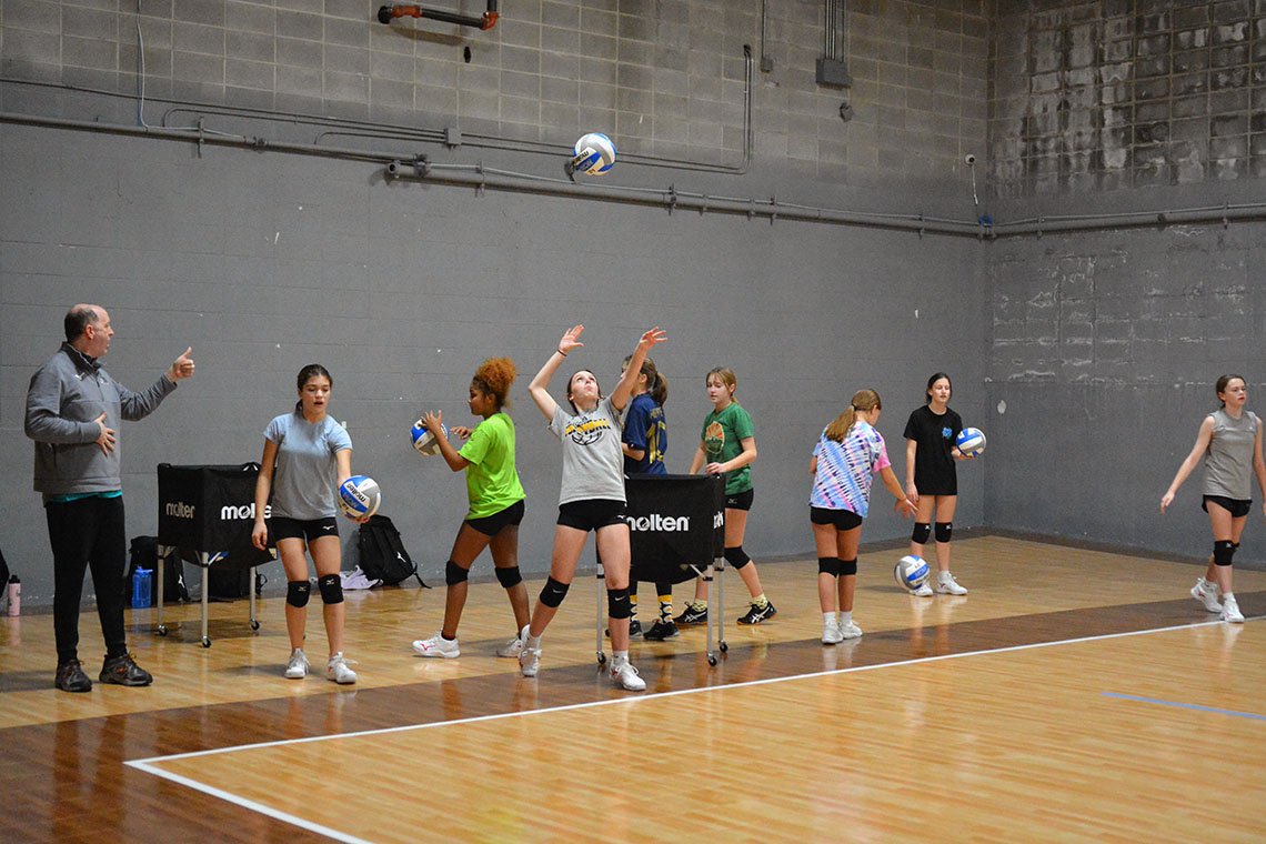 Eclipse Volleyball Club KC - Independence Club Volleyball Practice Location players serving court#1